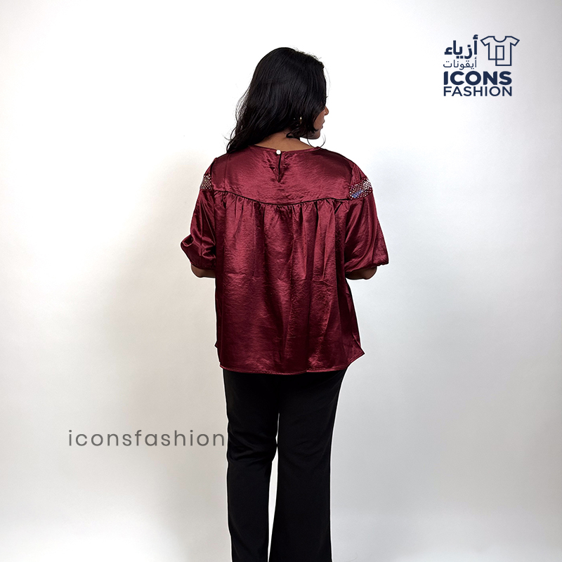 Wine-red-top-with-lace-detailing-across-the upper-chest-and-shoulders