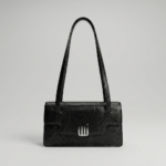 Black-structured-shoulder-bag-with-flap-closure-and-long-straps-textured-handbag